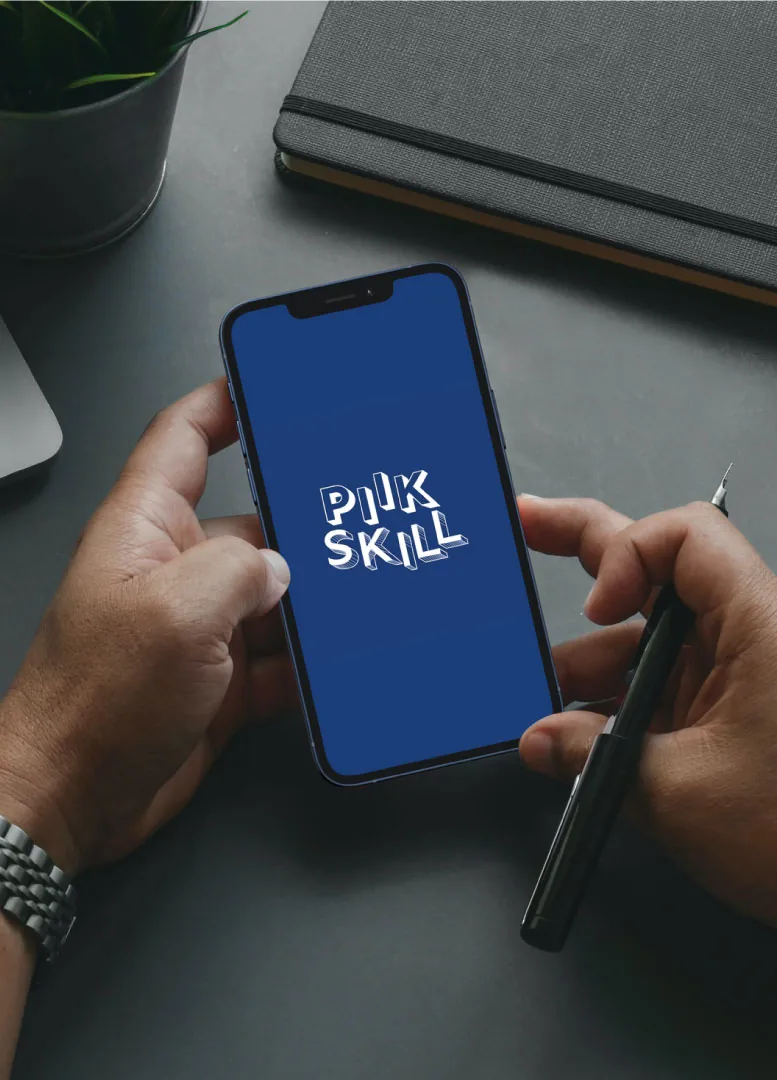 The PiikSkill app open on a phone held in both hands